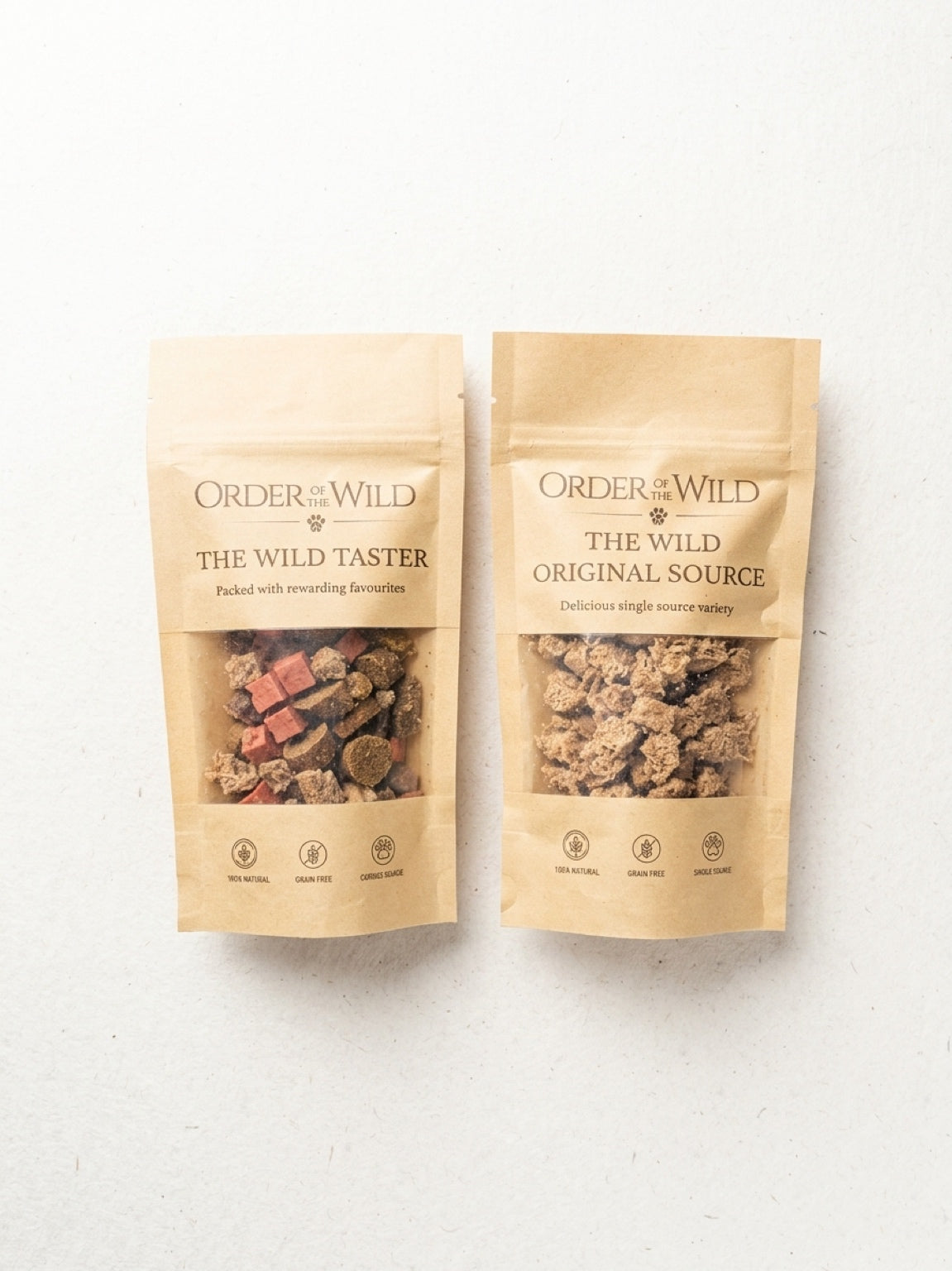 Two packages of 'Order of the Wild' pet treats on a white background