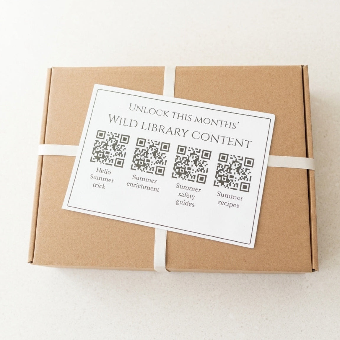 Brown cardboard box with a QR code label on a white background